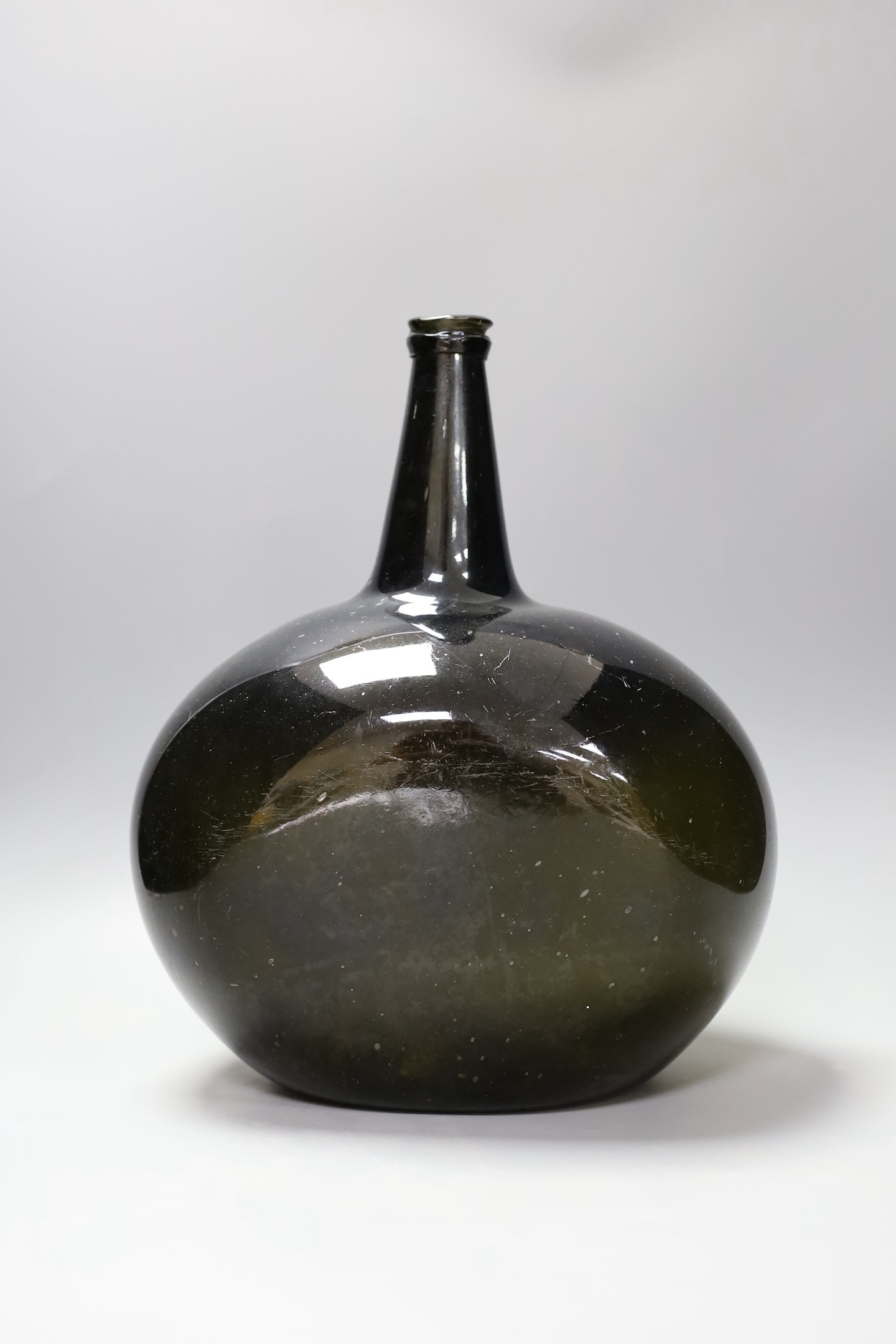 A large Georgian green glass bottle, 33 cm high and Nailsea-type ruby glass novelty pipe
